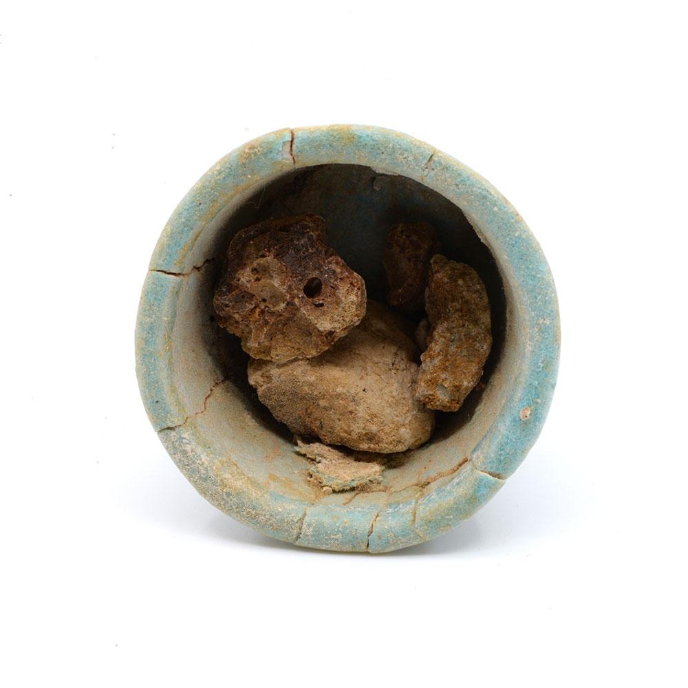 An Egyptian faience offering cup with contents, 26th Dynasty, ca. 664 - 525 BCE