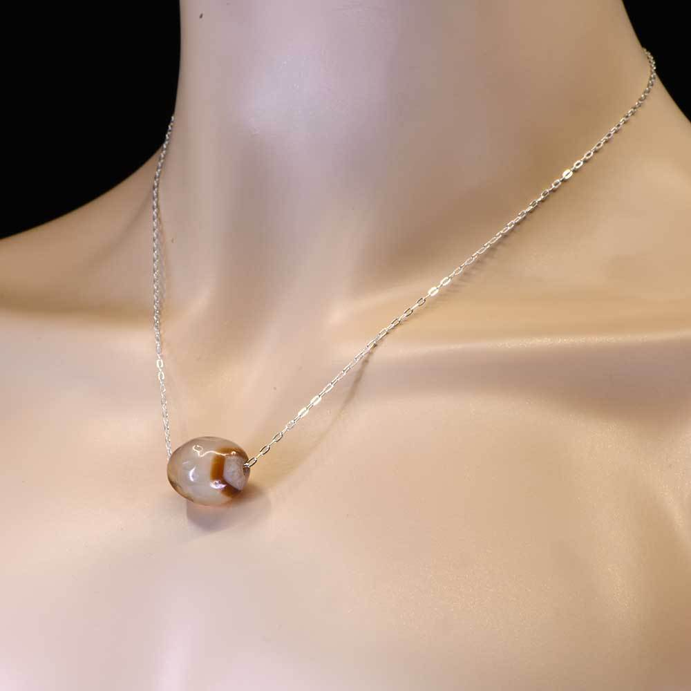 Eine als Anhänger gefasste gebänderte Achatperle aus dem Nahen Osten, ca. 1. Jahrtausend v. Chr.