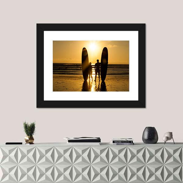 Surfer Couple Holding Long Surf Boards At Sunset On Beach Canvas Wall Art-1 Piece-Framed Print-20" x 16"-Tiaracle