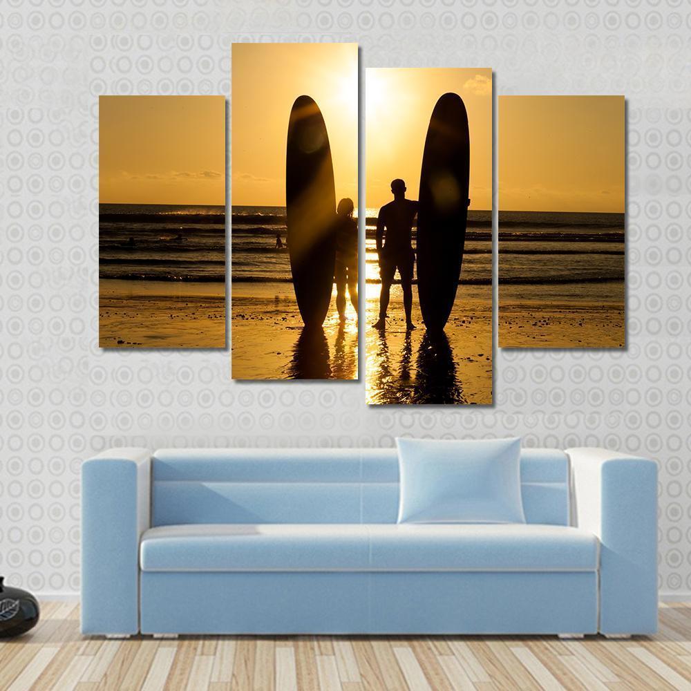 Surfer Couple Holding Long Surf Boards At Sunset On Beach Canvas Wall Art-4 Pop-Gallery Wrap-50" x 32"-Tiaracle