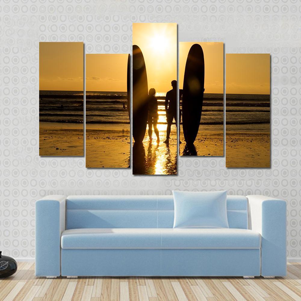 Surfer Couple Holding Long Surf Boards At Sunset On Beach Canvas Wall Art-5 Pop-Gallery Wrap-47" x 32"-Tiaracle